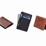 A lineup of stylish everyday carry wallets placed on a wooden desk