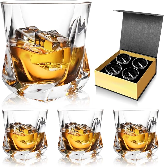 Classic whiskey glasses with a round rim and square base filled with bourbon and ice cubes